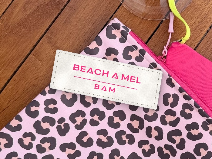 Hot-pink signature textile label on leopard pouch