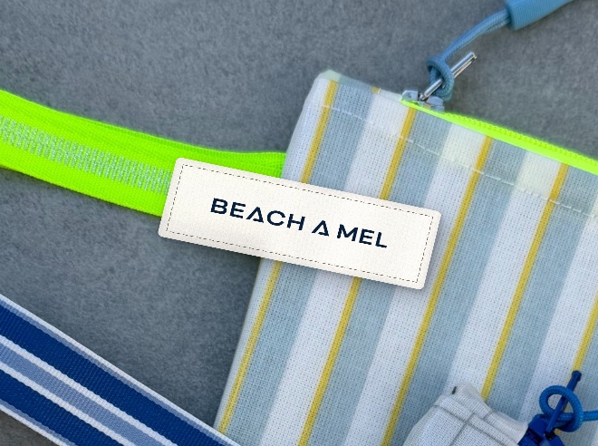 Small fabric label on striped map pouch